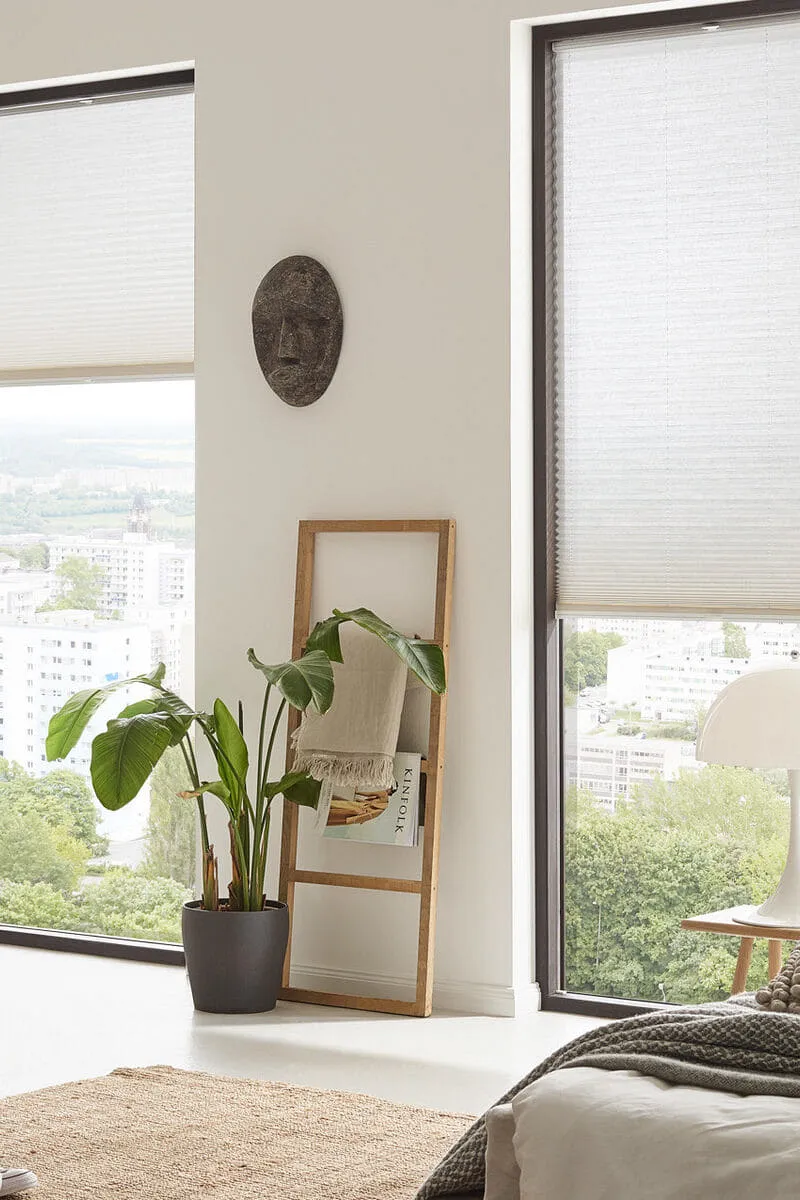 Plissee-Sonnenschutz an bodentiefen Fenstern im Wohnzimmer